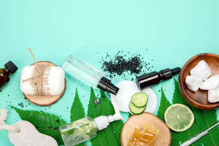 Face and body care products assortment on green background. natural cosmetics. Top view, flat lay, copy space.の写真素材