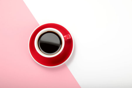 Coffee in red cup on color background. Hot drinks. Top view, flat lay, copy spaceの写真素材