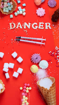 Mix of sweets and candy with sugar spread and written text in unhealthy nutrition, chocolate abuse and addiction concept, body and dental care. top view.の写真素材