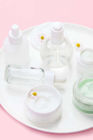 Face and body care products assortment on pink background. natural cosmetics. Top view, flat lay,...