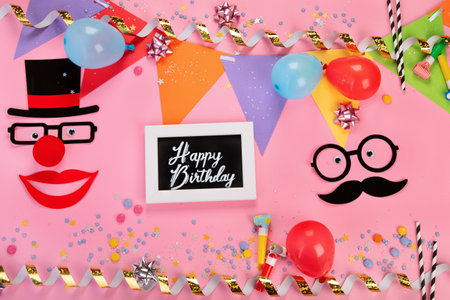 Funny faces on party pink background. Celebration concept. top view, copy spaceの写真素材