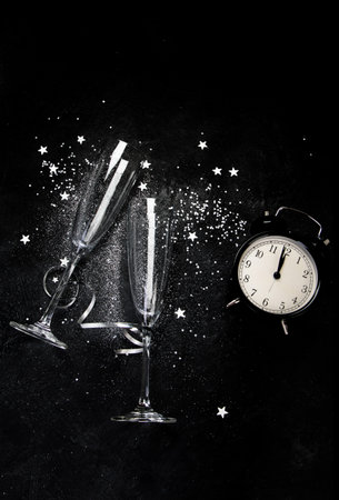 Two champagne glasses. Christmas decoration on a black background. Happy New Year Celebration. top view.の写真素材