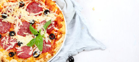 Freshly baked pizza on dark background. Tasty homemade food concept. top view, copy spaceの写真素材