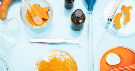 Medicine research of curcuma properties with the help of laboratory equipment, woman in gloves...
