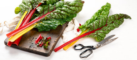 Raw chard on light background. Highly nutritious leaves. Popular component of healthy diets....
