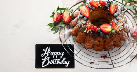 Bundt Cake with strawberry and berry on a light background. Festive cake. top view. Panorama with...