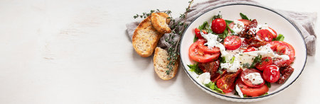 Tomato, basil, mozzarella. Caprese salad with olive oil. Top view, white background. Panorama with...