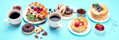 Summer or spring breakfast with Cup of hot cappuccino coffee, pancakes, waffles coffee, tulips...
