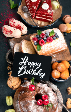 Different desserts on dark background. Delicious sweet dessert table with pound cake, chocolate and red velvet cakes. Holiday sweet eating concept. top viewの写真素材