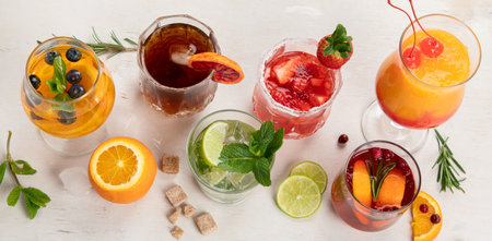 Different delicious cocktails on the table. Alcoholic cocktail with fruit, herbs and ice on a white background. top view. panorama.の写真素材
