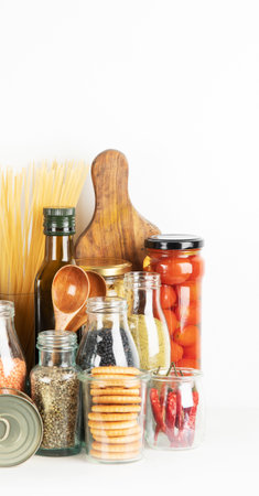 food supplies crisis food stock. Different glass jars with grains, pasta, cans of canned food on white background.の写真素材