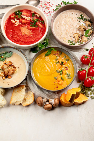 Variety of vegetables cream soups in small pots. top view. Concept of healthy eating or vegetarian food.の写真素材