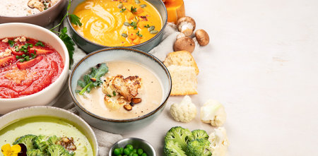 Variety of vegetables cream soups in small pots. top view. Concept of healthy eating or vegetarian food. Panorama with copy space.の写真素材