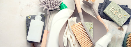 Eco brushes and cleaning products on light background. Eco Cleaner concept. Top view, copy space. panorama bannerの写真素材