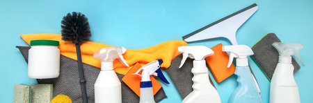 cleaning products. Bottles, rubber gloves and sponge. Housework concept, top view. panorama bannerの写真素材
