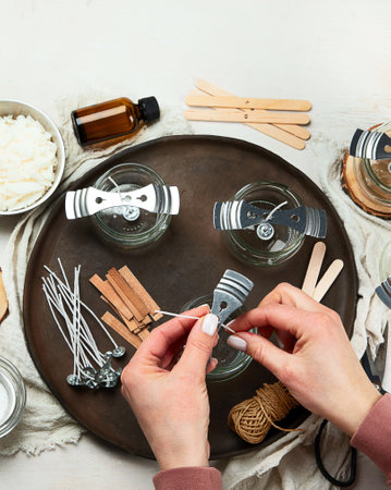 Set for homemade natural eco soy wax candles, Woman making decorative aroma candle at tableの写真素材