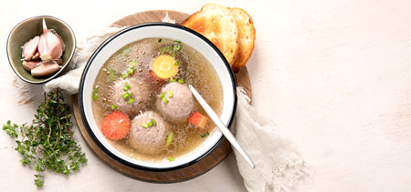 Knodel soup bowl and bread on light backround. panorama banner