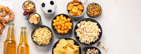 Beer bootles, snacks and balls on table. top view, copy spaceの写真素材