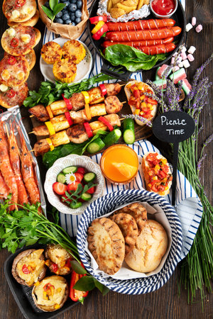 Various of grilled meal - grilled meats, vegetables, fruits, salad and potatoes on a dark wooden background. top view.の写真素材