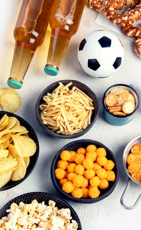 Beer bootles, snacks and balls on table. top view, copy spaceの写真素材