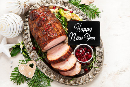 Christmas composition with baked ham on white background. traditional food concept. top view.の写真素材