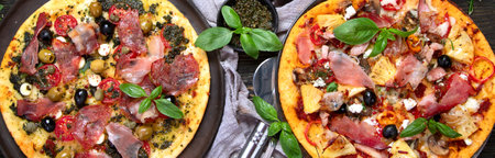 Hot tasty pizzas ready to eat. Homemade Meat Lovers Pizza with Pepperoni and Bacon on a wooden background, top view. Panorama, banner.の写真素材