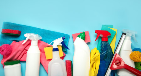 Cleaning supplies collection on blue background. Housework, cleaning service concept. Top view. Copy space.の写真素材