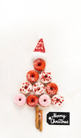Christmas tree made of sweet donuts. Top view, flat lay on light backgrounの写真素材
