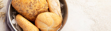 Baker or cooking chef holding fresh baked bread in hands on a light background. Concept of cooking.