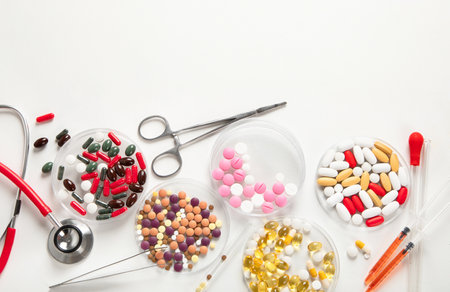 Differents pills and stethoscope on white background. Medicine concept. Top view, copy space.の写真素材