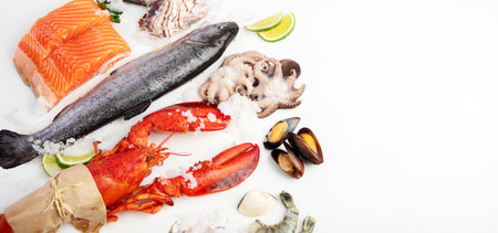 Various seafood and fishes dishes. Healthy food concept on white background, top view.の写真素材