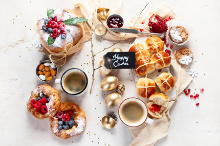 Easter table scene with an assortment of breads, desserts and treats on a white background. Top view. Spring holiday food concept.の写真素材