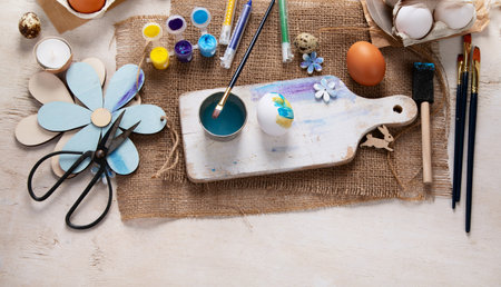 Happy Easter, painting eggs. Paints, pens, decorations for coloring eggs for holiday on a white background. Top view.の写真素材