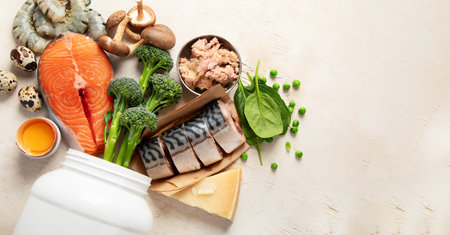 Natural sources of vitamin D (Fish, cheese, eggs, mushrooms, shrimps) on a white background. Top view. Panorama with copy space.の写真素材