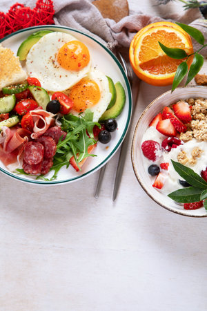 Healthy breakfast with oatmeal, berries, egg, bacon and a cup of coffee. Good morning. Top view, copy spaceの写真素材