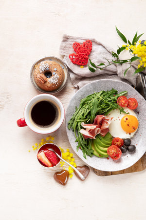 Healthy breakfast with oatmeal, berries, egg, bacon and a cup of coffee. Good morning. Top viewの写真素材