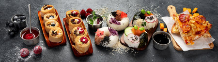 Hybrid trendy food on dark background. Sushi roll pancake, donut sushi, pizza with pasta. Copy space, bannerの写真素材