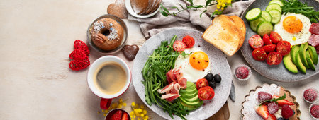 Breakfast served with coffee, fresh bakery, eggs, salad, meat and fruits. Holiday concept. Top view. Panorama with copy space.の写真素材