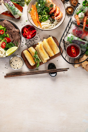 Assorted Asian meal, vietnamese food. Pho bo, noodles, spring rolls, sauces. Top view. Copy space.の写真素材