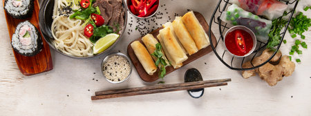 Assorted Asian meal, vietnamese food. Pho bo, noodles, spring rolls, sauces. Top view.の写真素材