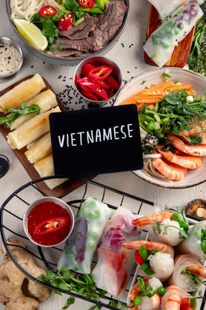 Assorted Asian meal, vietnamese food. Pho bo, noodles, spring rolls, sauces. Top view.の写真素材