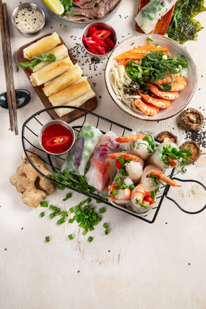 Assorted Asian meal, vietnamese food. Pho bo, noodles, spring rolls, sauces. Top view. Copy space.の写真素材