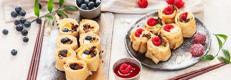Asian sweet sushi pancake. Rolls with cream cheese berry and fruits. Copy spaceの写真素材