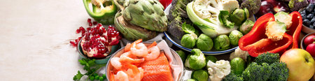 Vegetables, fish, berry on wooden background. Healthy food concept. Copy space, bannerの写真素材