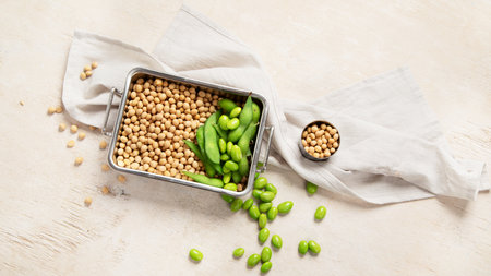 Soybeans on light cotton and wooden background. Vegan food concept. Top viewの写真素材