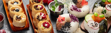 Hybrid trendy food on dark background. Sushi roll pancake, donut sushi, pizza with pasta. Top viewの写真素材