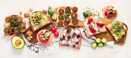 Breakfast with vegetables. toasts, tomato, cucumber, radish, avocado. Vegan healthy food concept. Top view, bannerの写真素材