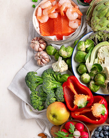 Vegetables, fish, berry on wooden background. Healthy food concept. Top view, copy spaceの写真素材