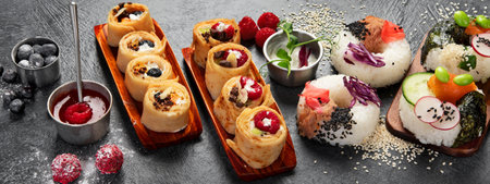 Hybrid trendy food on dark background. Sushi roll pancake, donut sushi, pizza with pasta. Bannerの写真素材