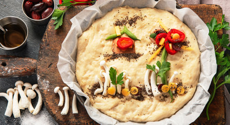 Italian food cooking. Raw focaccia art on dark background. Top viewの写真素材